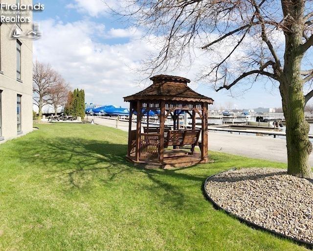 surrounding community with a gazebo and a yard