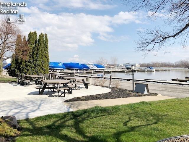 view of community with a water view and a lawn