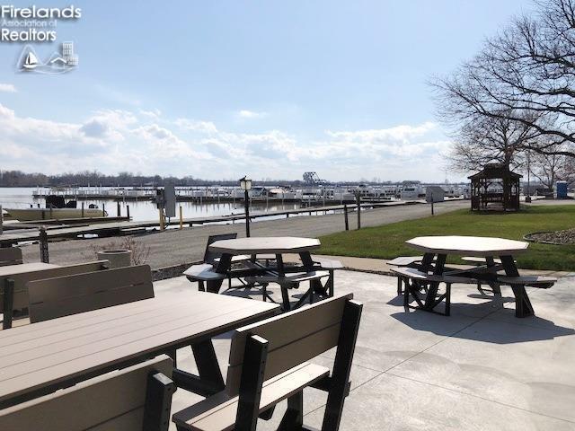 view of patio featuring a water view and a gazebo