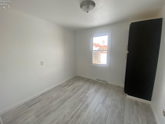 unfurnished room featuring light hardwood / wood-style floors