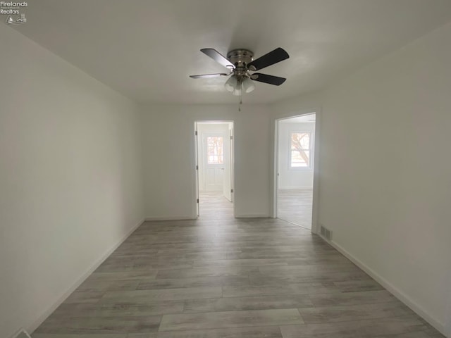 spare room featuring ceiling fan and light hardwood / wood-style flooring