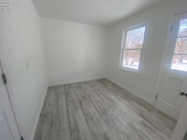 spare room with light hardwood / wood-style flooring