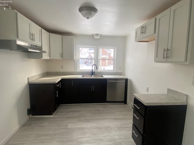 kitchen with sink, dishwasher, light hardwood / wood-style flooring, and white cabinetry