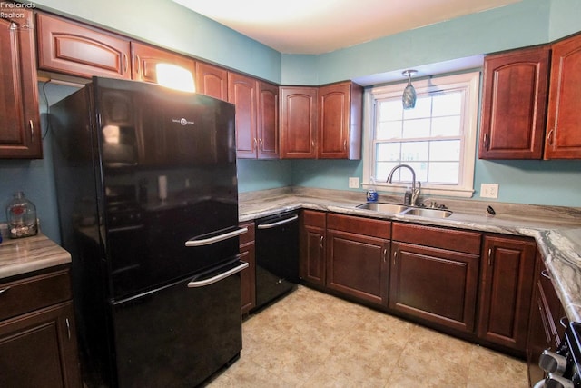 kitchen with black appliances, light stone counters, and sink