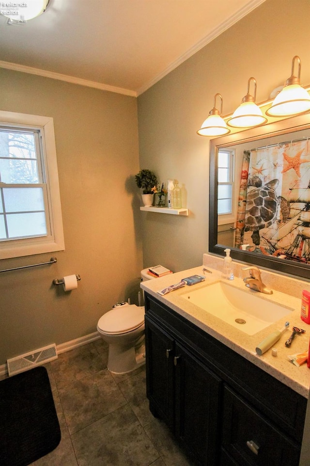 bathroom with toilet, crown molding, a healthy amount of sunlight, and vanity