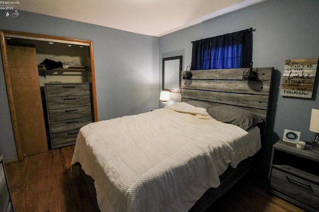 bedroom featuring a closet and dark hardwood / wood-style floors