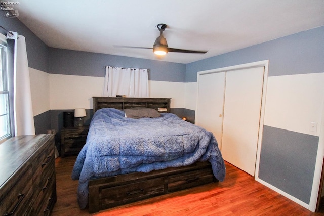 bedroom with ceiling fan, hardwood / wood-style floors, and a closet