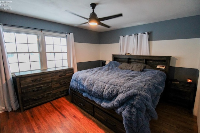 bedroom with hardwood / wood-style floors and ceiling fan