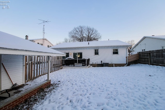 snow covered house with central AC