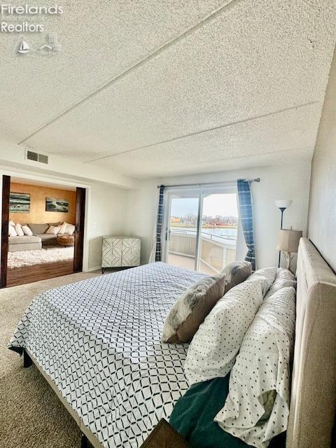 carpeted bedroom featuring a textured ceiling