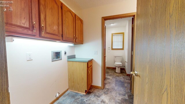 washroom featuring washer hookup, cabinets, and hookup for an electric dryer