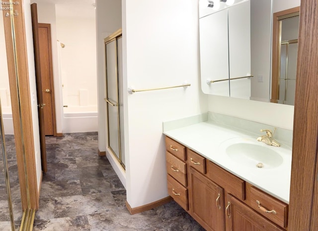 bathroom with a shower with door and vanity