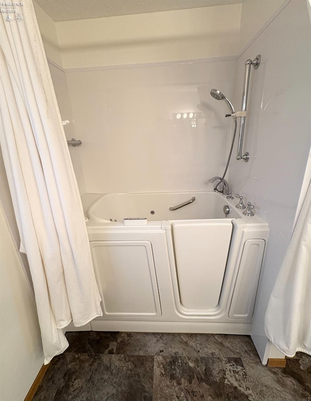 bathroom with shower / tub combo with curtain