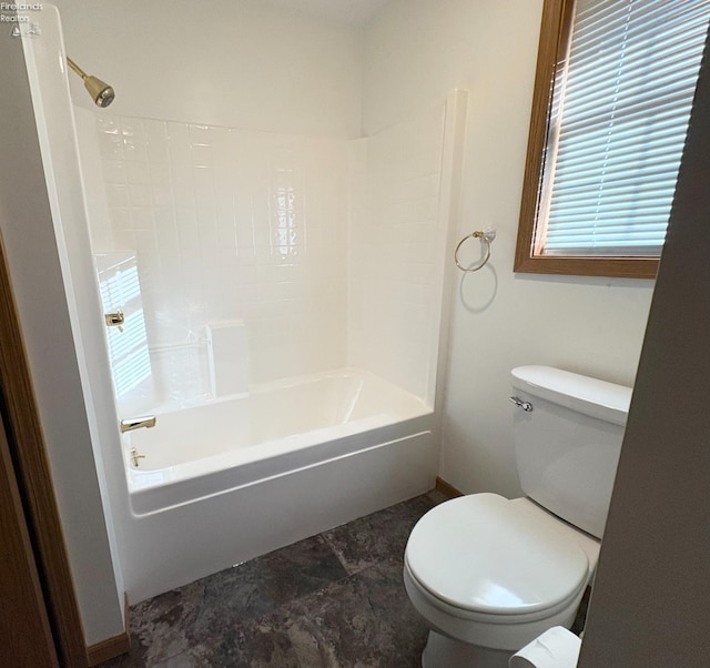 bathroom featuring toilet and bathing tub / shower combination