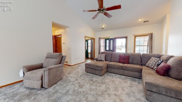 living room with high vaulted ceiling, ceiling fan, and light carpet