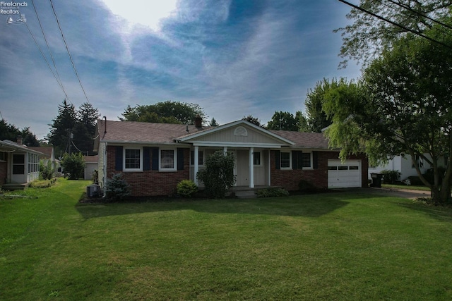 view of front of property with a garage and a front lawn