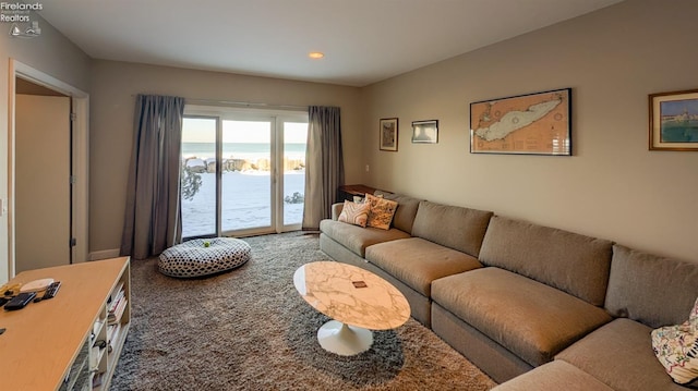 living room with carpet and a water view