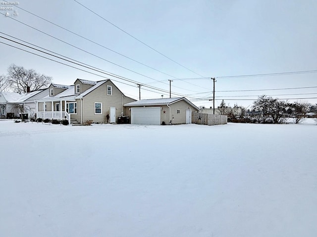 view of front of home with a porch, an outdoor structure, and a garage