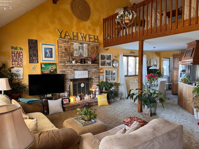 carpeted living room with a textured ceiling, a fireplace, and high vaulted ceiling