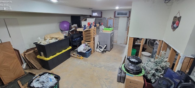 basement featuring washer / clothes dryer and a textured ceiling