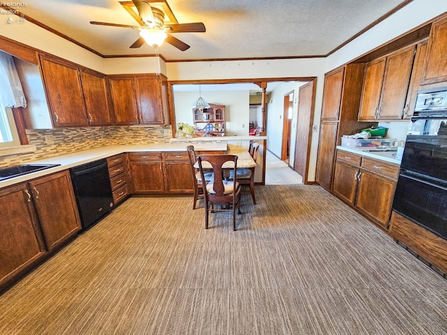 kitchen featuring ceiling fan, decorative backsplash, decorative light fixtures, black appliances, and sink