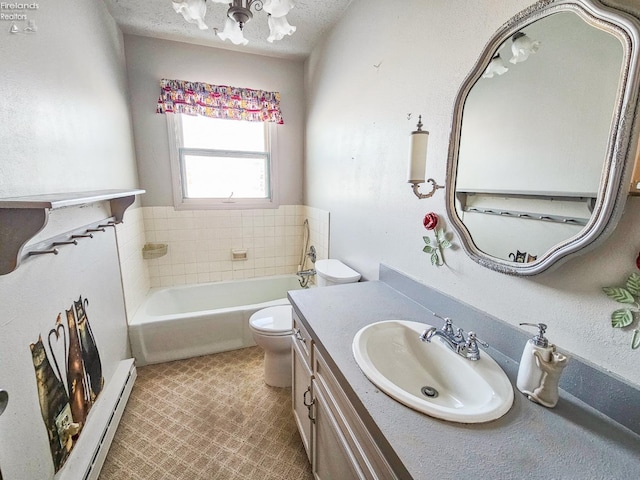 bathroom with a tub to relax in, vanity, a baseboard heating unit, and toilet