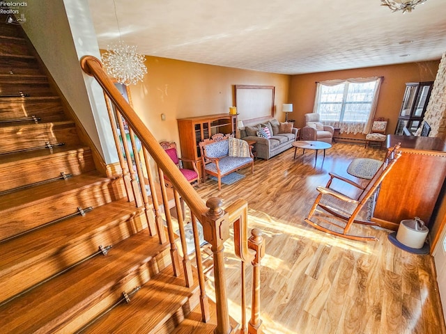 living room with a notable chandelier and hardwood / wood-style floors