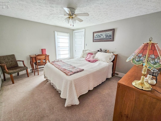 bedroom featuring ceiling fan, carpet, and a textured ceiling