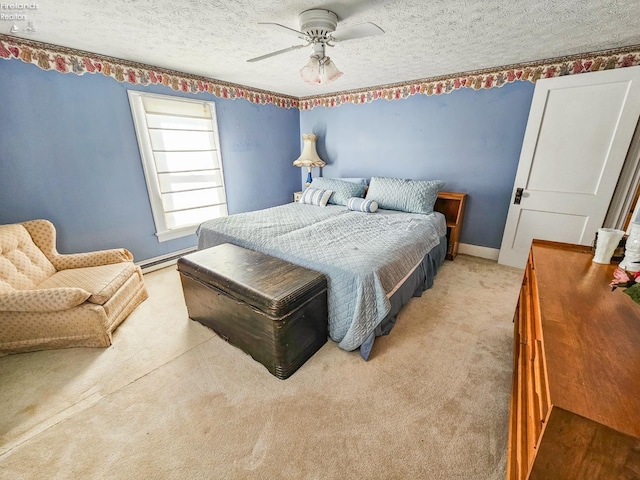 bedroom with ceiling fan, carpet, a textured ceiling, and a baseboard radiator