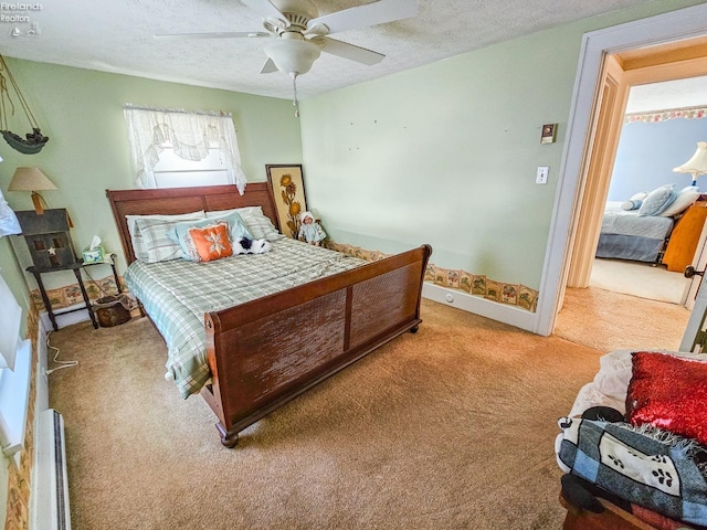 bedroom with ceiling fan, light colored carpet, and a textured ceiling