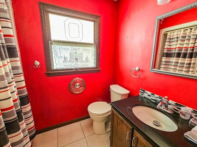 bathroom featuring toilet, tile patterned flooring, and vanity