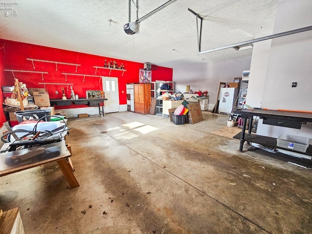 garage with a workshop area and a garage door opener