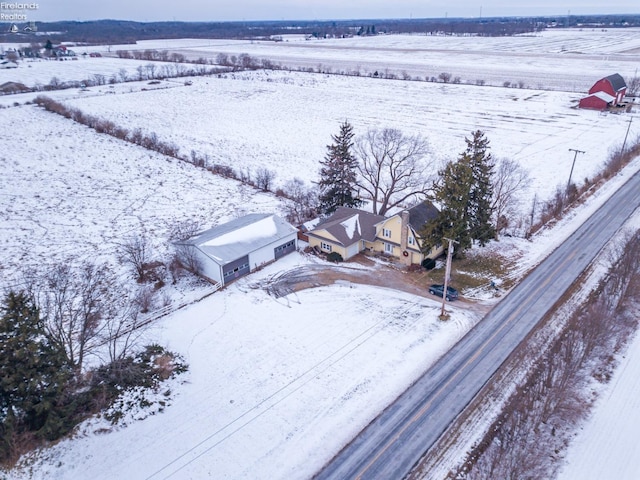 snowy aerial view featuring a rural view