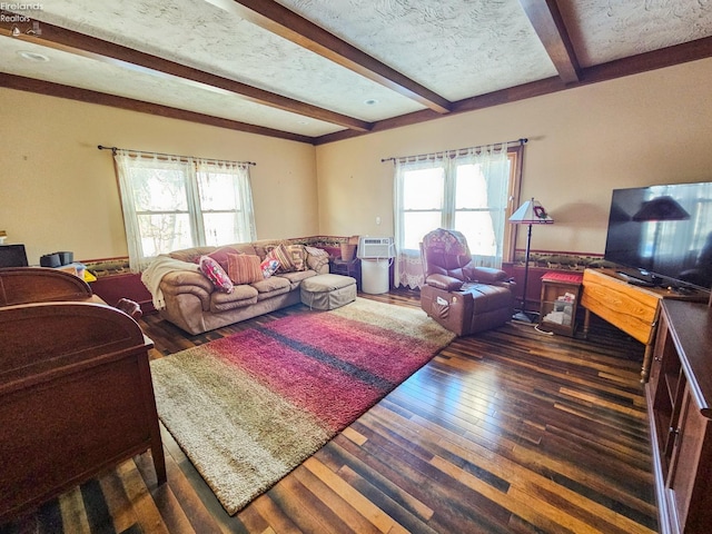 living room with a textured ceiling, dark hardwood / wood-style floors, and beam ceiling