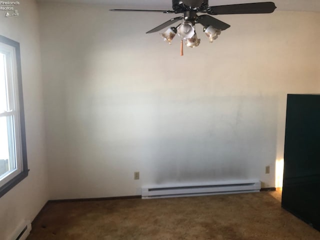 carpeted spare room featuring ceiling fan and baseboard heating