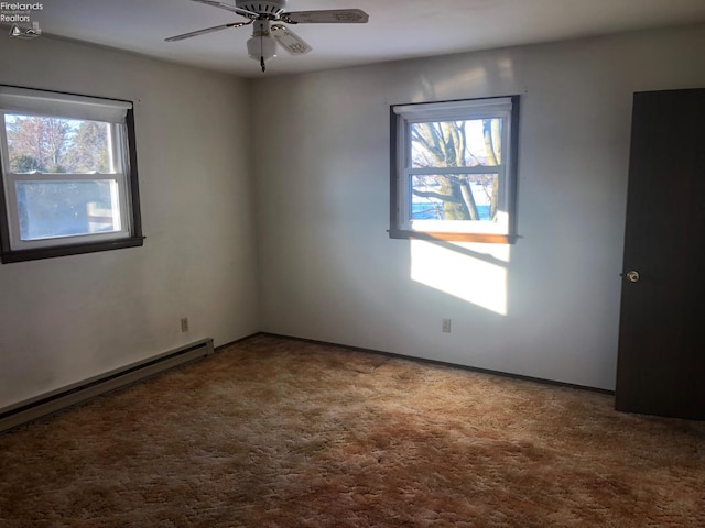 carpeted spare room featuring ceiling fan and a baseboard radiator