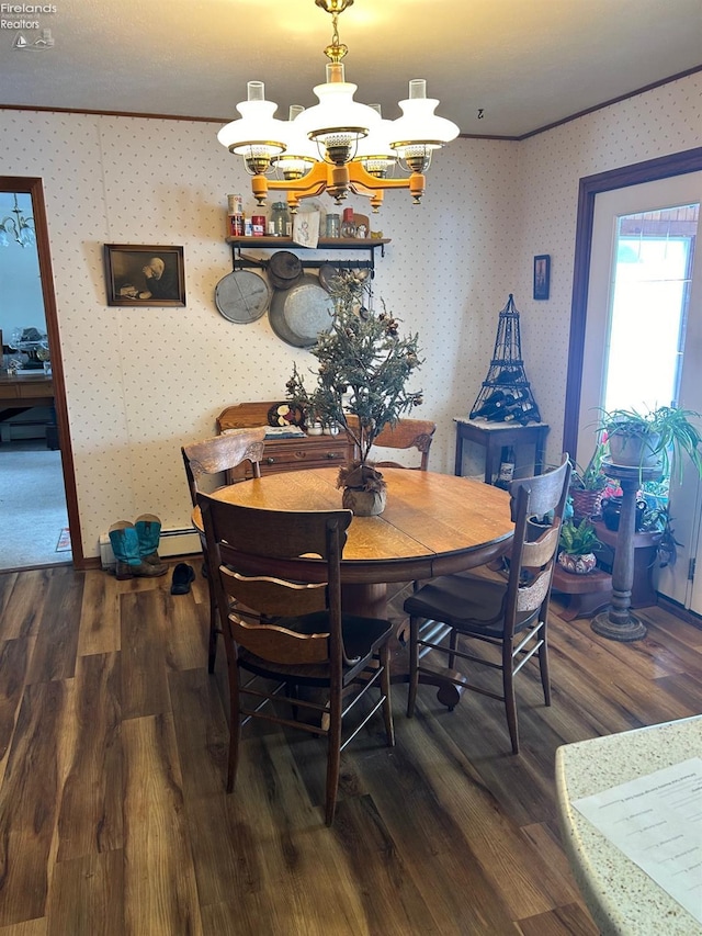 dining area with hardwood / wood-style flooring, ornamental molding, and a notable chandelier