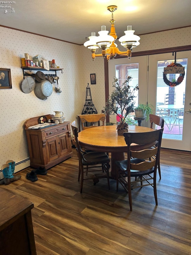 dining space featuring crown molding, dark hardwood / wood-style floors, an inviting chandelier, and a baseboard radiator