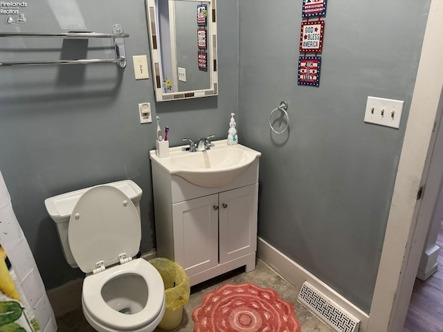 bathroom with toilet and vanity