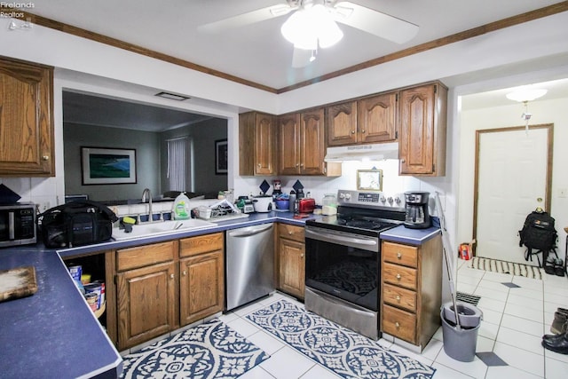 kitchen featuring light tile patterned floors, ceiling fan, stainless steel appliances, crown molding, and sink