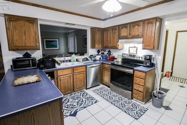 kitchen featuring ceiling fan, sink, light tile patterned flooring, appliances with stainless steel finishes, and ornamental molding