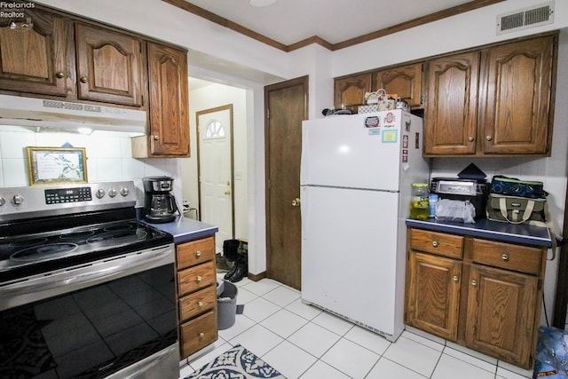 kitchen with tasteful backsplash, white fridge, electric range, ornamental molding, and light tile patterned floors