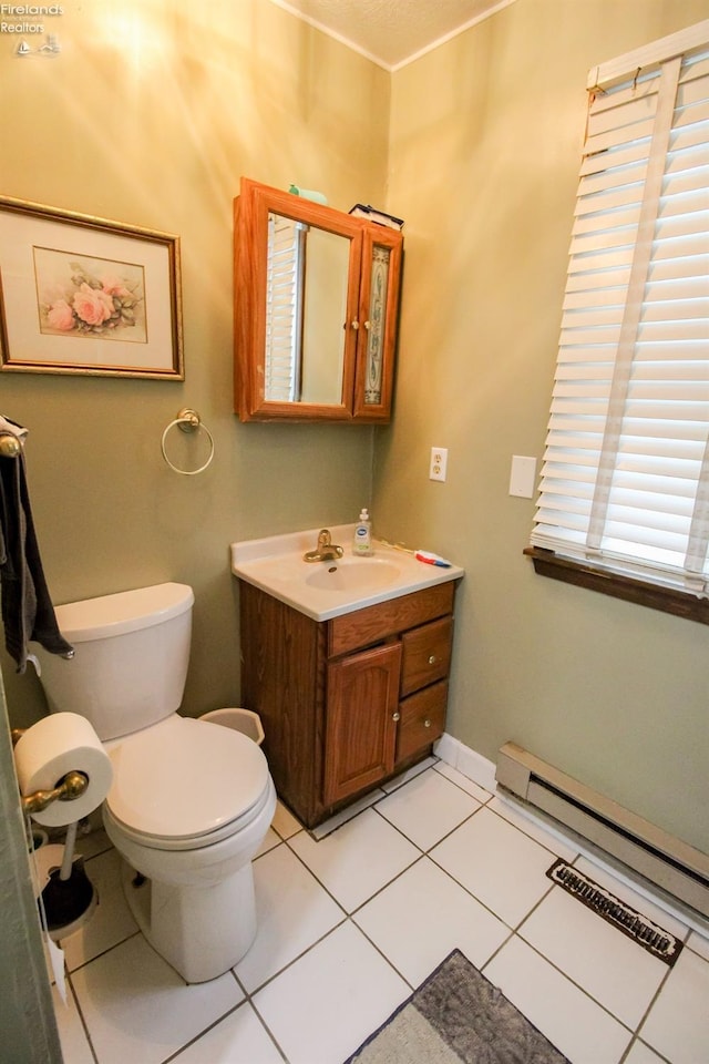 bathroom featuring a baseboard heating unit, toilet, tile patterned flooring, and vanity