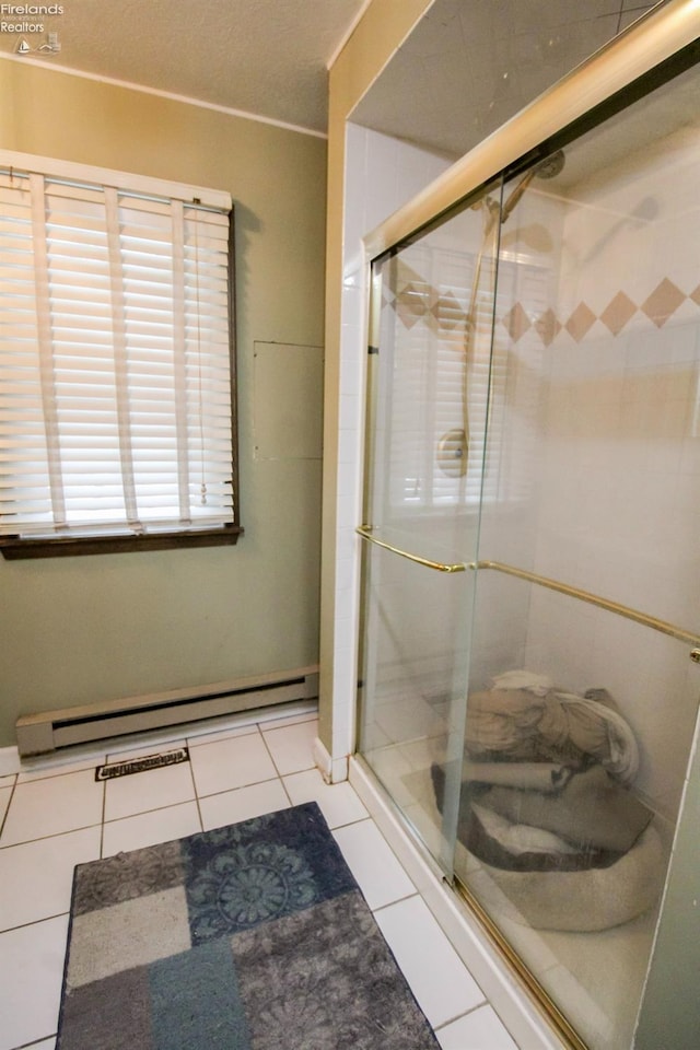 bathroom with baseboard heating, walk in shower, and tile patterned flooring