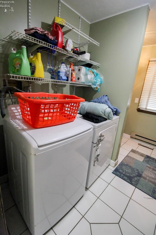 laundry room featuring washing machine and dryer, tile patterned floors, and a baseboard radiator