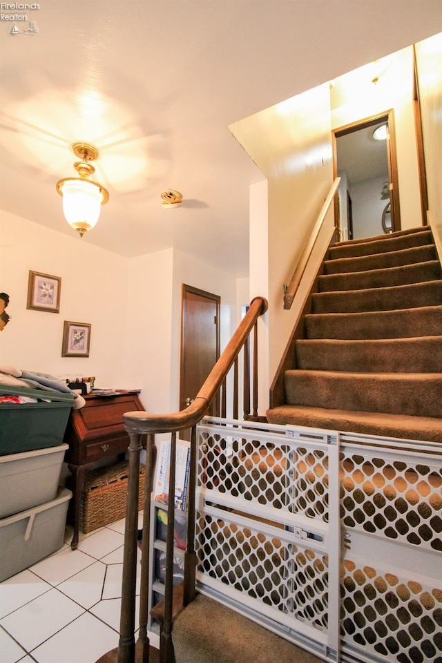 stairway with tile patterned flooring