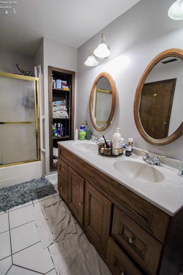 bathroom with tile patterned flooring, vanity, and shower / bath combination with glass door