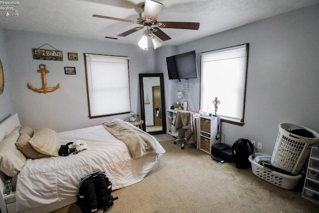 bedroom with ceiling fan and light colored carpet