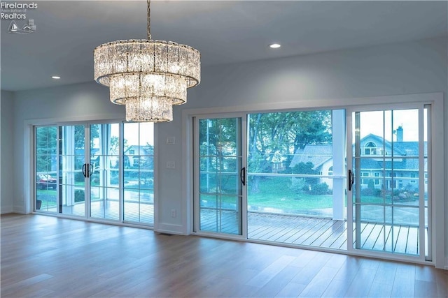 interior space with a chandelier and wood-type flooring