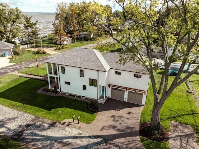 birds eye view of property with a water view